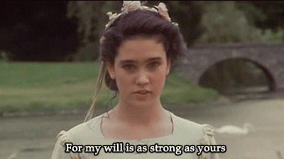 Sarah from Labyrinth, a teenage girl with brunette hair, wearing a medieval princess costume in a park and saying "For my will is as strong as yours".