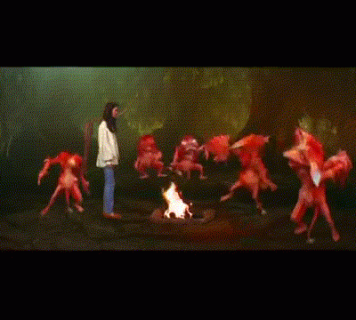 Sarah meets the Fire Gang, a group of fuzzy orange fire demons. They take off their heads and throw them while dancing around a campfire.